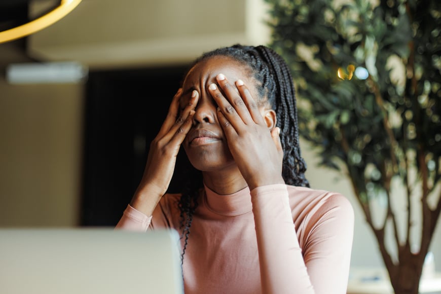 woman feeling fatigue and rubbing her eyes